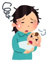 赤ちゃんを抱えて育児につかれている様子の母親