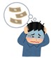 お金のことで悩んでおり頭を抱えている男性