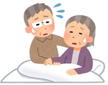 高齢男性が高齢女性を介護して疲れている様子の高齢男性
