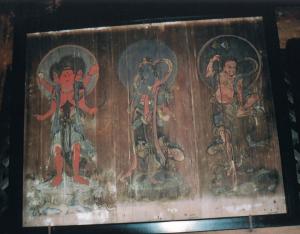 3体の菩薩が様々なポーズをとっている古びた絵画の写真